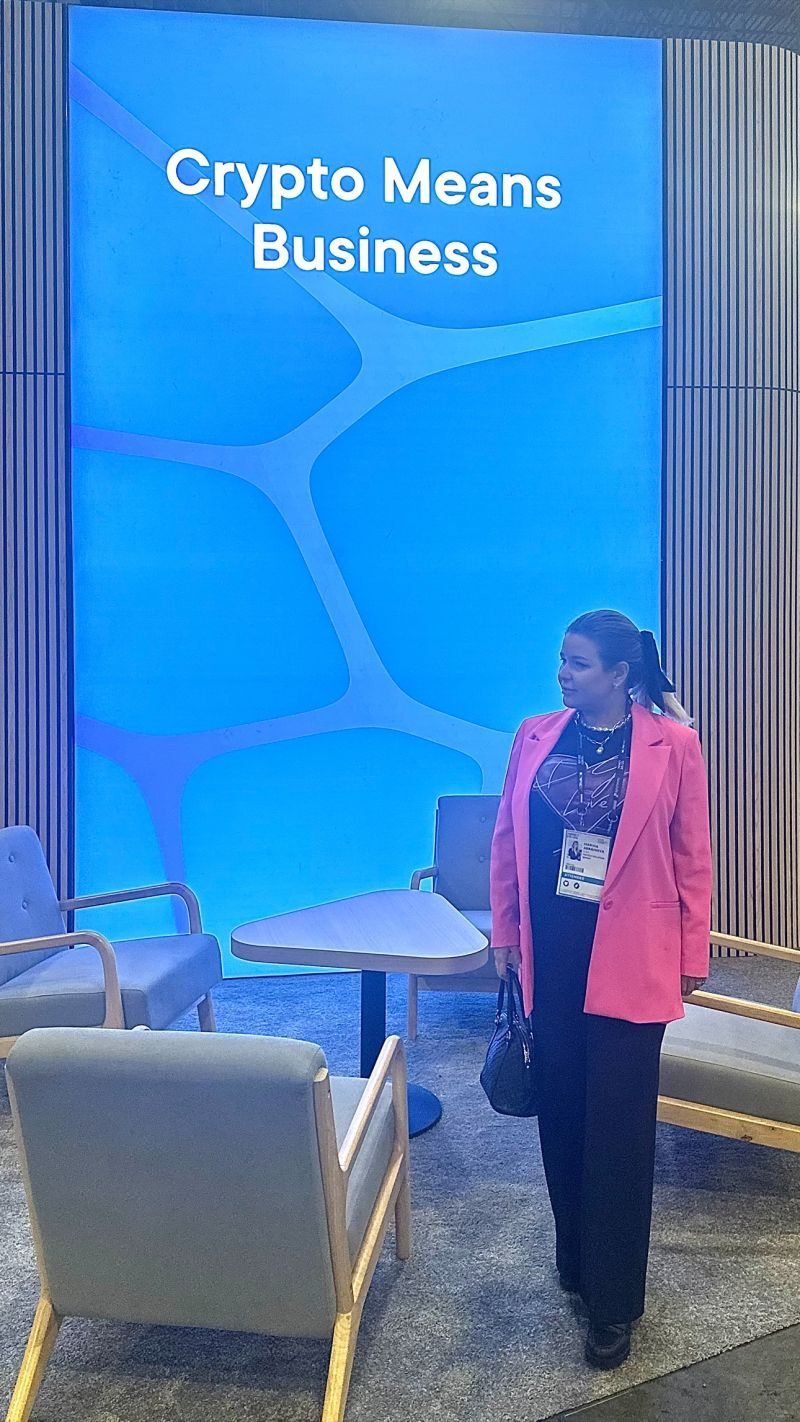 Event photo at a crypto industry conference, backdrop reading Crypto Means Business